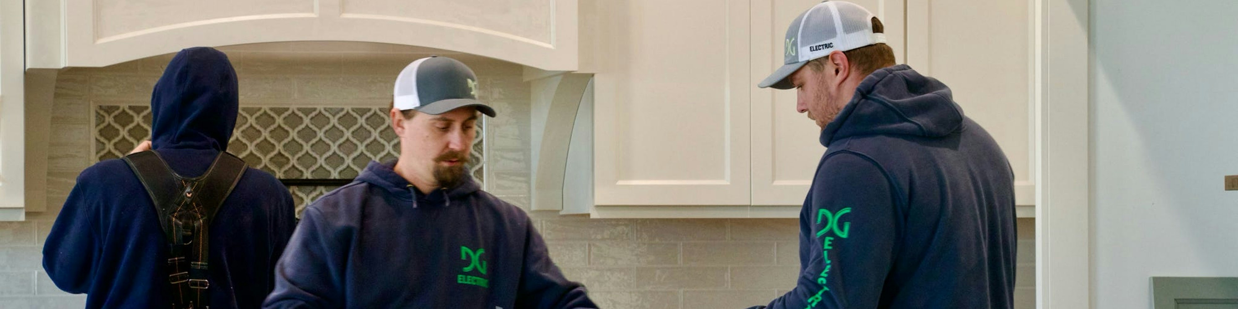 DG Eelectric team working together in a kitchen.